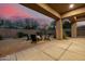 Cozy outdoor patio with a brick tile area, and a fire pit with seating for nighttime entertainment at 7152 E Night Glow Cir, Scottsdale, AZ 85266