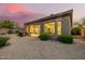 Cozy backyard with desert landscaping, fire pit, and covered patio at 7152 E Night Glow Cir, Scottsdale, AZ 85266