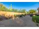 Desert landscaping featuring gravel, cacti, and lush bushes surround the rear patio of the home at 7152 E Night Glow Cir, Scottsdale, AZ 85266