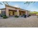 Desert landscaped backyard featuring a covered patio and a fire pit at 7152 E Night Glow Cir, Scottsdale, AZ 85266