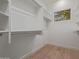 Walk-in closet featuring custom shelving and a window for natural light at 7152 E Night Glow Cir, Scottsdale, AZ 85266