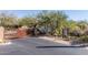Community entrance featuring an ornate metal gate and lush desert landscaping at 7152 E Night Glow Cir, Scottsdale, AZ 85266