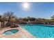 Inviting community pool and spa featuring desert landscaping and comfortable lounge seating at 7152 E Night Glow Cir, Scottsdale, AZ 85266