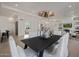 Well-lit dining room with contemporary chandelier, seating for six, and open-concept design at 7152 E Night Glow Cir, Scottsdale, AZ 85266