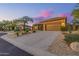 Lovely desert home featuring a three-car garage and gravel landscaping at 7152 E Night Glow Cir, Scottsdale, AZ 85266