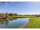 Picturesque golf course view with a serene pond and lush green landscaping at 7152 E Night Glow Cir, Scottsdale, AZ 85266