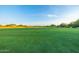 Scenic golf course view showcasing lush green fairway and a clear blue sky at 7152 E Night Glow Cir, Scottsdale, AZ 85266