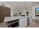 Open-concept kitchen featuring a large island with seating, modern appliances, and seamless flow to the living area at 7152 E Night Glow Cir, Scottsdale, AZ 85266
