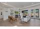 Spacious living room featuring a stone fireplace, built-in shelves, and access to the backyard at 7152 E Night Glow Cir, Scottsdale, AZ 85266