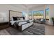 Bright, spacious main bedroom with large windows, modern decor, a plush bed, and a cozy seating area at 7152 E Night Glow Cir, Scottsdale, AZ 85266