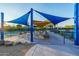 Outdoor seating area with shade structures and tables, ideal for relaxation and socializing by the courts at 7152 E Night Glow Cir, Scottsdale, AZ 85266