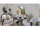 Bright sitting room with four chairs, natural light, and views of the serene outdoor space at 7152 E Night Glow Cir, Scottsdale, AZ 85266