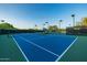 Well-maintained blue tennis courts with lighting, ready for games day or night at 7152 E Night Glow Cir, Scottsdale, AZ 85266