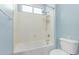 Bathroom tub/shower with a showerhead and a built in shelf at 7169 W Lamar Rd, Glendale, AZ 85303