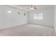 Bright bedroom with neutral carpet, three windows, and a ceiling fan at 7169 W Lamar Rd, Glendale, AZ 85303