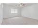 Spacious bedroom with neutral carpet, natural light, and a ceiling fan at 7169 W Lamar Rd, Glendale, AZ 85303