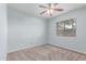 This is a light blue bedroom with neutral carpet and a ceiling fan at 7169 W Lamar Rd, Glendale, AZ 85303