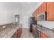 A modern kitchen featuring granite countertops, stainless steel appliances, and ample cabinet space at 7169 W Lamar Rd, Glendale, AZ 85303