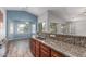 Open kitchen featuring granite countertops, stainless steel appliances, and a breakfast bar at 7169 W Lamar Rd, Glendale, AZ 85303