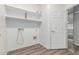 A laundry room with open shelves and a utility sink connection at 7169 W Lamar Rd, Glendale, AZ 85303