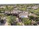 Beautiful desert home boasts mature palms, desert landscaping, a circular driveway, and an outdoor living area with a pool at 7640 E Poinsettia Dr, Scottsdale, AZ 85260