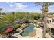 Aerial view of the landscaped backyard and custom pool with a spa and rock features at 7640 E Poinsettia Dr, Scottsdale, AZ 85260