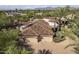 An aerial view showcases the tile roof and the three-car garage on the property at 7640 E Poinsettia Dr, Scottsdale, AZ 85260