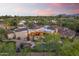 Picturesque backyard oasis featuring a custom pool, mature palms, and a private patio perfect for relaxing or entertaining at 7640 E Poinsettia Dr, Scottsdale, AZ 85260