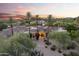 Stunning Mediterranean home featuring desert landscaping, tile roof, and mountain views at sunset at 7640 E Poinsettia Dr, Scottsdale, AZ 85260