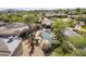 Aerial showcasing the luxurious backyard pool, patio area, desert landscaping, and lush greenery at 7640 E Poinsettia Dr, Scottsdale, AZ 85260