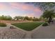 Spacious backyard features a manicured lawn, desert landscaping, and ample space for outdoor activities at 7640 E Poinsettia Dr, Scottsdale, AZ 85260