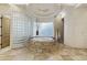 Luxurious bathroom with a raised round tub, travertine tile, and privacy glass wall at 7640 E Poinsettia Dr, Scottsdale, AZ 85260