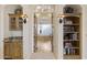 Arched entry to a circular tub area, with decorative lighting and shelving at 7640 E Poinsettia Dr, Scottsdale, AZ 85260