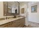 Elegant bathroom featuring granite countertops, double sinks, and a decorative mirror at 7640 E Poinsettia Dr, Scottsdale, AZ 85260