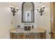 Stylish powder room with a vessel sink, granite counters, and ornate sconces at 7640 E Poinsettia Dr, Scottsdale, AZ 85260