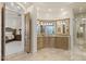 Primary bathroom with double vanity, granite countertops, and an arched entry to main bedroom at 7640 E Poinsettia Dr, Scottsdale, AZ 85260