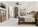 Bedroom with fireplace, built-in cabinets, arched doorways and window seat at 7640 E Poinsettia Dr, Scottsdale, AZ 85260