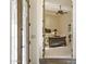 Bedroom with neutral carpet, a ceiling fan, and entry door with decorative glass at 7640 E Poinsettia Dr, Scottsdale, AZ 85260