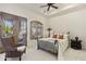 Cozy bedroom with ceiling fan, outdoor access, and plush armchair at 7640 E Poinsettia Dr, Scottsdale, AZ 85260