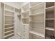 Walk-in closet with custom shelving, drawers, and ample storage space at 7640 E Poinsettia Dr, Scottsdale, AZ 85260