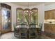 Inviting dining area with wood table, chandelier, shutters, and adjacent custom cabinets at 7640 E Poinsettia Dr, Scottsdale, AZ 85260
