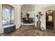 Elegant dining room with a large round table, seating for eight, and a wine cellar nearby at 7640 E Poinsettia Dr, Scottsdale, AZ 85260