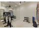 Exercise room with mirrored wall, weights, and stationary bike for your home gym at 7640 E Poinsettia Dr, Scottsdale, AZ 85260