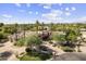 A beautiful home featuring mature palm trees, desert landscaping, and a circular driveway at 7640 E Poinsettia Dr, Scottsdale, AZ 85260