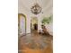 A grand foyer featuring a high ceiling, custom tile floor, statement chandelier, and an elegant chair at 7640 E Poinsettia Dr, Scottsdale, AZ 85260