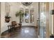 A grand foyer featuring a high ceiling, custom tile floor, statement chandelier, and an elegant chair at 7640 E Poinsettia Dr, Scottsdale, AZ 85260