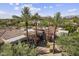 Aerial showcasing lush landscaping, desert plants, and home's circular architecture at 7640 E Poinsettia Dr, Scottsdale, AZ 85260