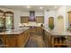 Large kitchen with double islands, custom cabinetry, stainless steel appliances, and stone tile flooring at 7640 E Poinsettia Dr, Scottsdale, AZ 85260