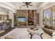Bright living room with stone fireplace, built-in cabinets, and bar, seamlessly connecting living spaces at 7640 E Poinsettia Dr, Scottsdale, AZ 85260