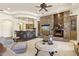Spacious living area showcasing a stone fireplace, wet bar, and comfortable seating arrangement at 7640 E Poinsettia Dr, Scottsdale, AZ 85260